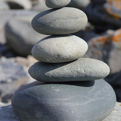 Smooth stones stacked on top of each other, symbolizing balance.